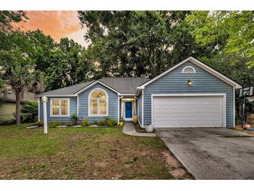 Charming blue home featuring an attached garage, front yard, and inviting entrance at 1309 Llewellyn Rd, Mount Pleasant, SC 29464