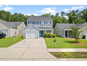 Charming two-story home with blue accents, a one-car garage, and a well-manicured front lawn at 251 Coosawatchie St, Summerville, SC 29485