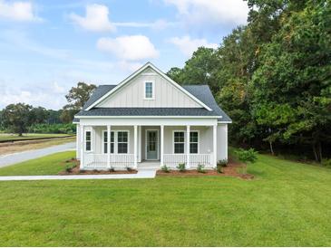 Charming single-story home featuring a welcoming front porch and a well-manicured lawn at 2872 Edenborough Rd, Johns Island, SC 29455