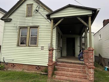 Exterior view of a two-story home featuring a front porch with brick steps at 6 Orrs Ct, Charleston, SC 29403