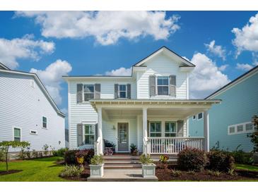 Charming two-story home with a welcoming front porch, landscaped yard, and great curb appeal under a bright sky at 1801 Sandybrook Dr, Mount Pleasant, SC 29466