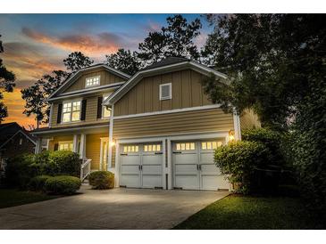 Charming two-story home with a two-car garage and professionally landscaped front yard at sunset at 188 Donning Dr, Summerville, SC 29483