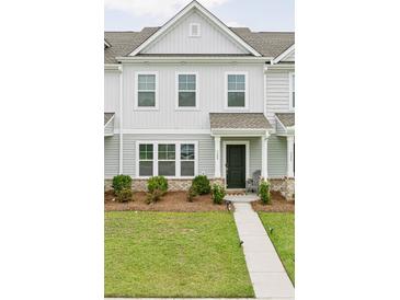 Charming townhome with a well-manicured lawn and covered front porch at 328 Surfbird Rd, Summerville, SC 29486