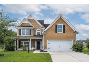 Charming two-story home featuring a well-maintained lawn, attached two-car garage, and inviting front porch at 3807 Canary Ct, North Charleston, SC 29420