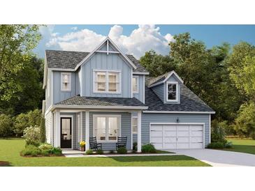 Charming two-story home with light blue siding, a covered porch, and a two-car garage on a well-manicured lawn at 88 French Garden Cir, Summerville, SC 29486