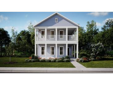 Charming two-story home featuring a double-decker front porch and landscaped front yard at 1041 Scotch Bonnet Way, Summerville, SC 29485