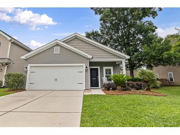 Charming home featuring a gray facade, well-manicured lawn, and a convenient two-car garage at 1460 Oldenburg Dr, Mount Pleasant, SC 29429