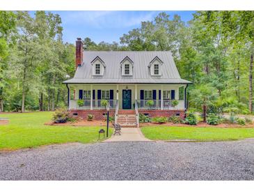 Charming home featuring a metal roof, dormer windows, brick foundation, and a welcoming front porch at 196 Dogwood Ridge Rd, Summerville, SC 29485
