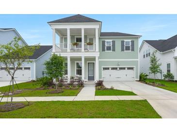 Charming two-story home with inviting front porch, balcony, and manicured lawn at 198 Steepbrook Dr, Summerville, SC 29486