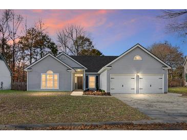 Charming single-Gathering home with a two-car garage, manicured lawn, and classic architectural details at 207 Thomaston Ave, Summerville, SC 29485
