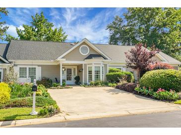 Charming single-story home with a well-manicured lawn and inviting curb appeal under a beautiful blue sky at 2438 Hansard Dr, North Charleston, SC 29406