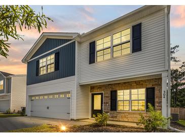 Two-story home with blue and white siding, stone accents, a two-car garage, and well-maintained landscaping at 304 Torslanda Ln, Summerville, SC 29486
