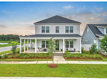 Charming two-story home featuring a spacious front porch and beautifully landscaped front yard at 501 Rhythm St, Summerville, SC 29486