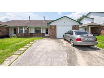 Charming single-story home featuring a brick facade, attached garage, and a well-maintained front yard at 7621 Oldridge Rd, North Charleston, SC 29418