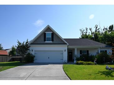 Charming single-story home with a well-maintained front yard and attached two-car garage at 8127 Saveur Ln, Charleston, SC 29406