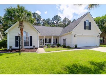 Charming single-story home with a well-manicured lawn, palm tree, and inviting front porch at 9133 Markleys Grove Blvd, Summerville, SC 29485