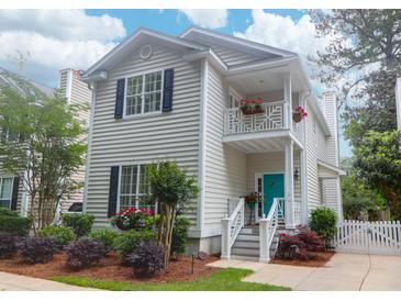 Charming two-story home boasts a second-story balcony and a vibrant turquoise front door at 1025 Mathis Ferry Rd, Mount Pleasant, SC 29464