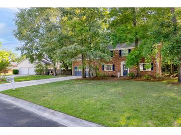 Charming brick home with a lush green lawn and mature trees providing ample shade at 103 Sylvan Ter, Summerville, SC 29485