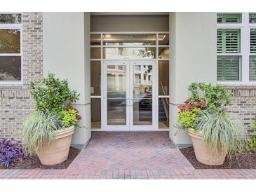 Inviting entrance to a residential building with double glass doors and attractive planters at 125 Pier View St # 209, Charleston, SC 29492