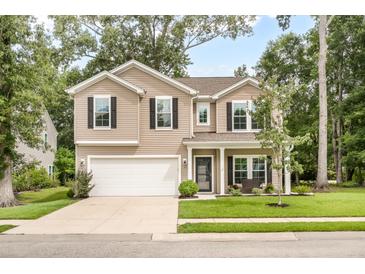 Charming two-story home with manicured lawn, attached two-car garage and welcoming front porch with a bench at 1309 Belgian Draft Dr, Mount Pleasant, SC 29466