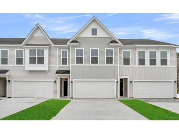 Charming townhomes with attached garages and manicured lawns at 138 Brown Swiss Cir, Summerville, SC 29483