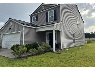 Two-story home with gray siding, black shutters, green lawn, and a covered front porch with white pillars at 167 Brittondale Rd, Summerville, SC 29485