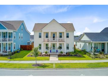 Charming two-story home featuring double porches, manicured lawn, and a welcoming blue front door at 176 Midtown Ave, Summerville, SC 29486
