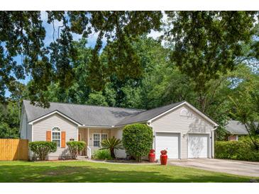 Charming single-Gathering home with a well-manicured lawn, a two-car garage, and mature trees at 1975 Fruitwood Ave, Charleston, SC 29414