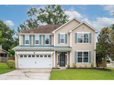 Charming two-story home featuring a well-manicured lawn, two-car garage, and inviting curb appeal at 201 Old Market Ct, Moncks Corner, SC 29461