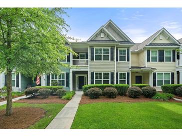 Charming townhome featuring manicured landscaping and a welcoming front porch at 2064 Promenade Ct, Mount Pleasant, SC 29466