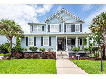 Charming two-story home with a welcoming front porch, manicured lawn, and mature trees at 2632 Alderly Ln, Mount Pleasant, SC 29466