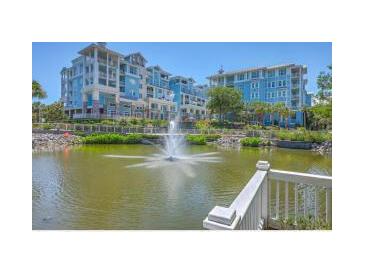 Scenic view of a building complex overlooking a pond with a fountain at 5802 Palmetto Dr # B314, Isle of Palms, SC 29451