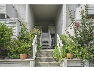 Exterior stairway leading to upper-level residences, surrounded by lush greenery at 607 Greencastle Dr, Goose Creek, SC 29445
