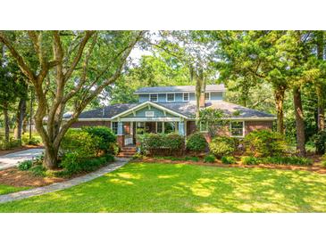 Charming two-story brick home with lush landscaping and mature trees at 802 Robert E. Lee Blvd, Charleston, SC 29412