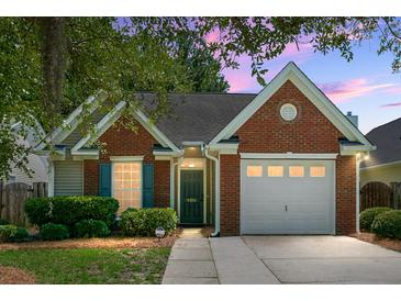 Charming single-story brick home with a well-maintained yard and attached one car garage at dusk at 9255 Ayscough Rd, Summerville, SC 29485
