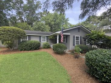 Charming home featuring a well-manicured lawn, manicured shrubs, and tasteful landscaping adding curb appeal at 963 Yorktown Dr, Charleston, SC 29412