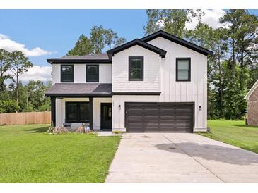 Charming two-story home with modern farmhouse design, white siding, black trim, and inviting front porch at 1000 Retreat Ave, Moncks Corner, SC 29461