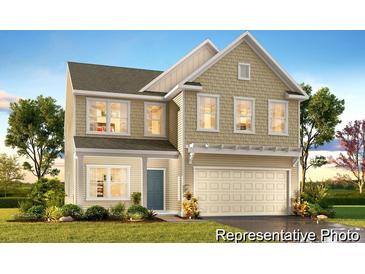 Charming two-story home with a welcoming front porch and manicured lawn at 1009 Marsh Harrier Dr # Cc3-2-2P, Ravenel, SC 29470