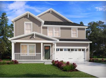 Charming two-story home featuring a covered porch, attached garage, and beautifully landscaped front yard at 101 Indigo Cove Blvd, Summerville, SC 29486