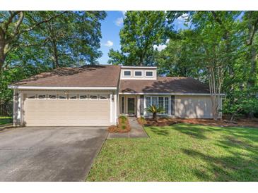 Charming single-story home featuring a two-car garage and a well-manicured lawn at 1129 Shady Grove Ln, Mount Pleasant, SC 29464