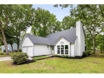 Charming home featuring a well-manicured lawn, lush trees, and a classic white exterior at 1478 Diamond Blvd, Mount Pleasant, SC 29466