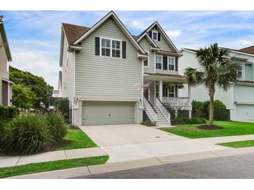 Charming two-story home with light grey siding, a front porch, and a well-maintained yard at 2241 Dewees Creek Dr, Mount Pleasant, SC 29466