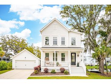 Charming two-story home with white siding, a welcoming front porch, and lush landscaping at 2815 Colonel Harrison Drive Dr, Johns Island, SC 29455