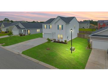 Charming two-story home featuring a manicured lawn and a well-lit street in a Gathering-friendly neighborhood at 330 Bountiful Dr, Moncks Corner, SC 29461