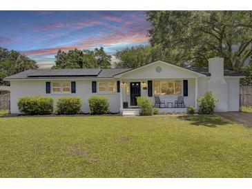 Charming home with a well-manicured front yard and solar panels at 1032 Windward Rd, Charleston, SC 29412