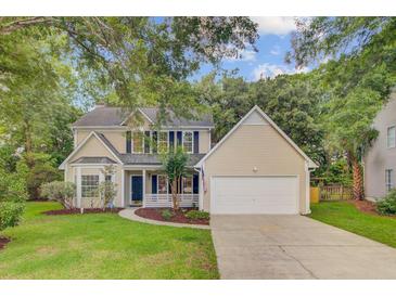 Charming home featuring well-maintained landscaping, attached garage, and inviting front porch at 1253 Horseshoe Bnd, Mount Pleasant, SC 29464