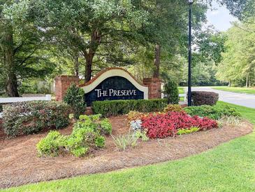Welcoming entrance sign for 'The Preserve' with lush landscaping and manicured lawn at 126 Thousand Oaks Cir, Goose Creek, SC 29445