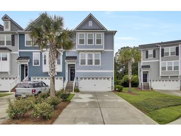 Charming townhome showcasing a blue exterior, two-car garage, and driveway at 1550 Spring Moss Rd, Mount Pleasant, SC 29466