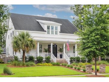 Charming two-story home with a welcoming front porch, manicured lawn and beautiful landscaping at 1903 Bolden Dr, Mount Pleasant, SC 29466