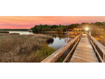 Beautiful waterfront home with a private dock and boat lift, perfect for enjoying sunsets at 4385 Ten Shillings Way, Ravenel, SC 29470
